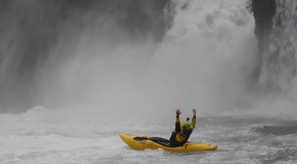 Italian Kayaker Matthias Weger celebrating a sick run off a waterfall with his kayak